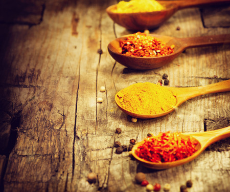 Various spices and herbs over wooden backgroundの写真素材