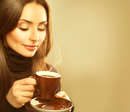 Coffee. Beauty Model Woman with the Cup of Hot Drink