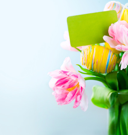 Easter holiday flowers bunch with greeting card. Colorful tulipsの写真素材