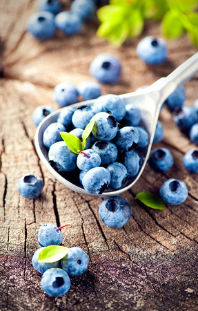 Blueberry on wooden background. Ripe and juicy fresh picked blueberries closeupの写真素材