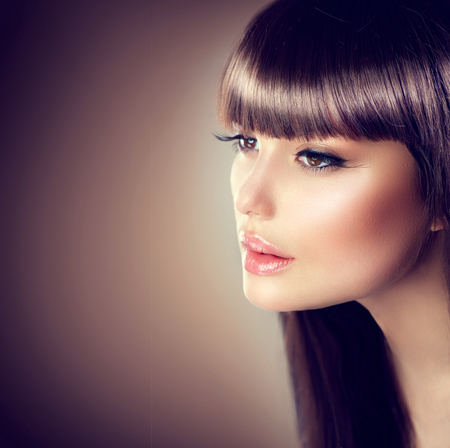 Beauty woman with beautiful make up and healthy smooth brown hair