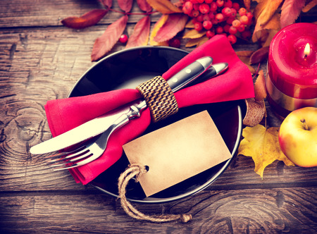 Thanksgiving wooden table served, decorated with bright autumn leavesの写真素材