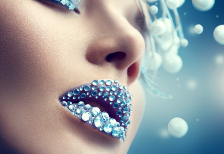 Christmas girl. Holiday makeup with gems on lipsの写真素材