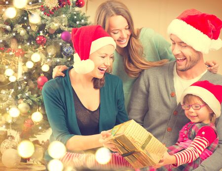 Happy smiling family at home celebrating Christmasの写真素材