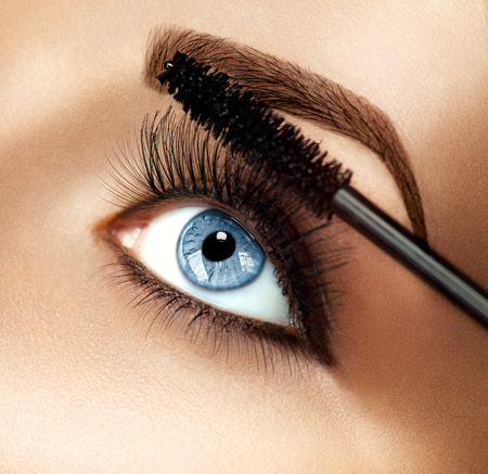 Mascara makeup applying closeup. Eyelashes extensionsの写真素材
