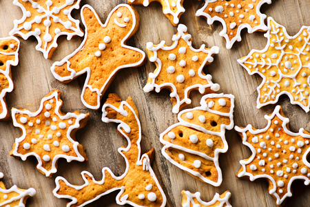 Holiday background with various gingerbread cookies over wooden tableの写真素材