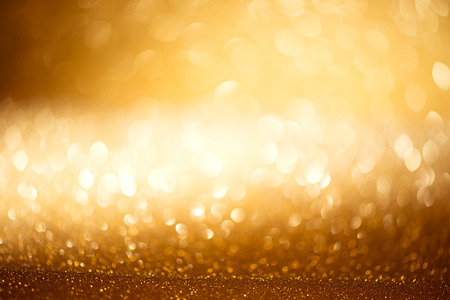 Golden Christmas holiday glowing defocused backgroundの写真素材