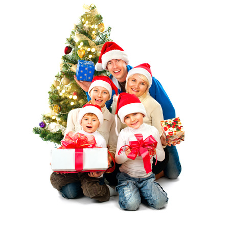 Happy Christmas family with gifts isolated on whiteの写真素材
