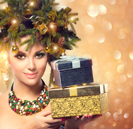 Winter woman holding New Year giftsの写真素材