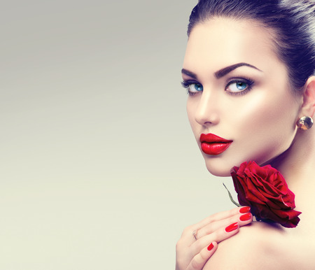 Beauty fashion model woman face. Portrait with red rose flower