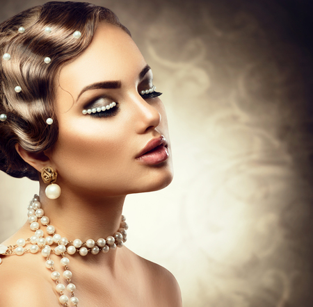 Retro styled makeup with pearls. Beautiful Young woman portraitの写真素材