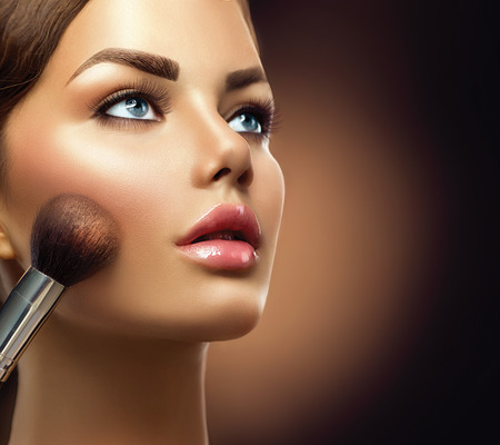 Makeup. Beauty model girl applying make-up closeupの写真素材