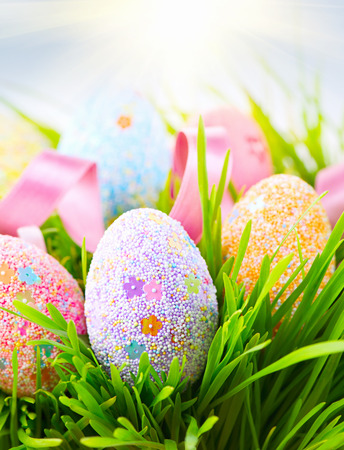 Easter colorful eggs on green spring grassの写真素材