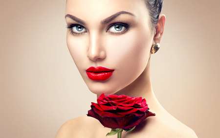 Beauty fashion model woman face. Portrait with red rose flowerの写真素材