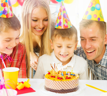 Birthday kids party. Happy big family celebrating birthday of little boyの写真素材