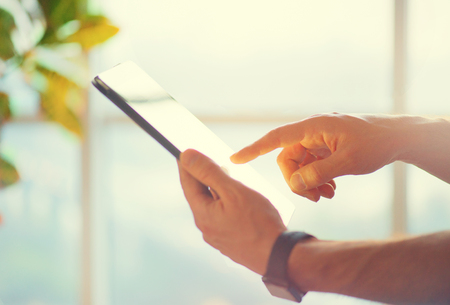 Person using smart watch and connecting with tablet pcの写真素材