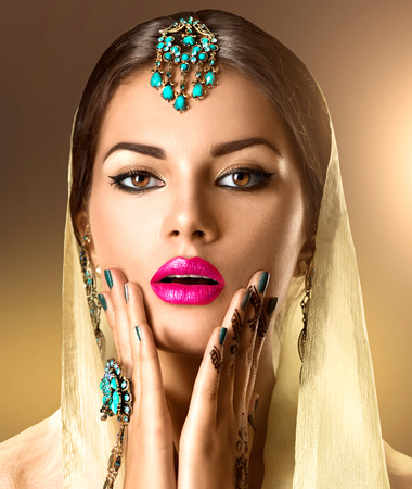 Beauty Indian woman portrait. Model girl with mehndi tattoo on her handsの写真素材