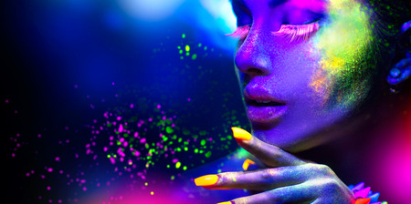 Fashion woman in neon light, portrait of beauty model with fluorescent makeupの写真素材