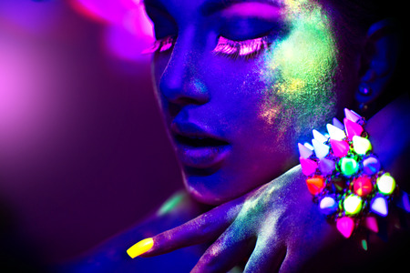 File name:Fashion model woman in neon light, portrait of beautiful model girl with fluorescent make-upの写真素材