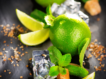 Ingredients of Mojito. Lime, mint, ice cubes and brown sugarの写真素材