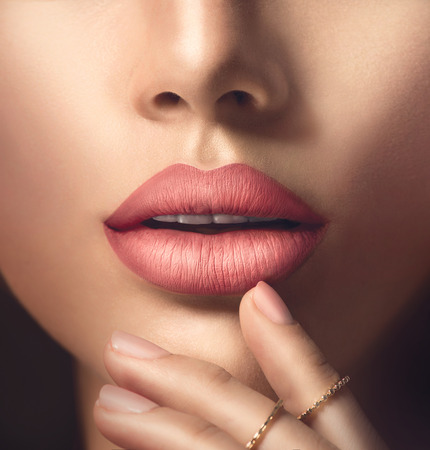 Perfect woman's sensual lips with fashion natural beige matte lipstick makeupの写真素材