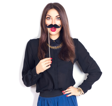 Joyful model girl holding funny mustache on stickの写真素材
