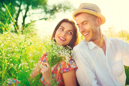 Happy young couple enjoying nature outdoorsの写真素材