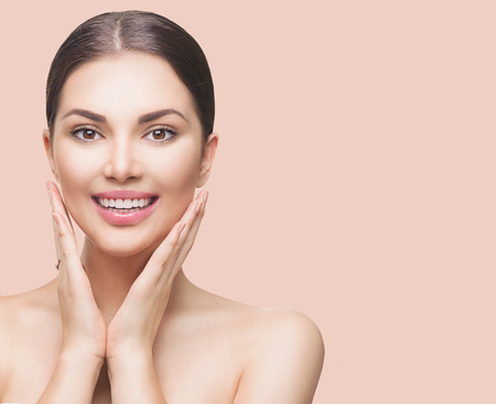 Beauty spa woman touching her face and smilingの写真素材