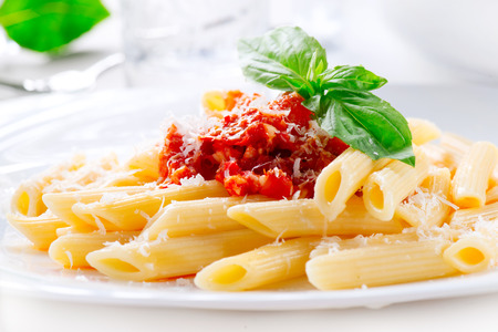 Pasta Penne with Bolognese sauce, Parmesan cheese and Basilの写真素材
