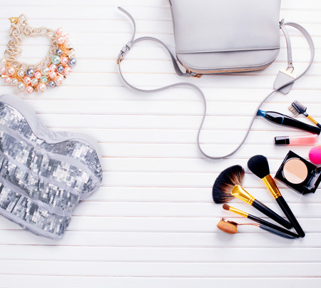 Woman's clothing and accessories placed on a wooden backgroundの写真素材