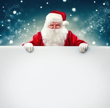 Santa Claus holding blank advertisement banner background with copy spaceの写真素材