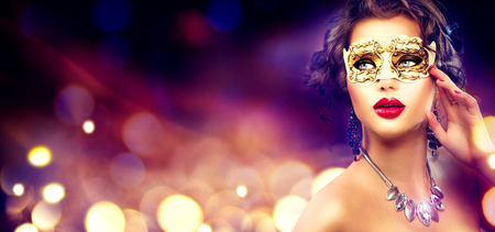 Beauty model woman wearing venetian masquerade carnival mask at partyの写真素材