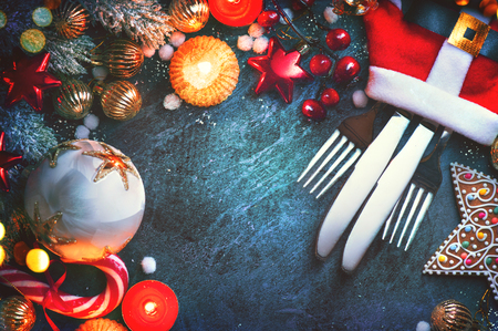 Christmas holiday table settings. Holiday served table with baubles, candles and decorationsの写真素材