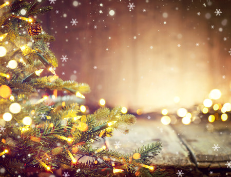 Christmas holiday blurred background with Christmas tree and garlandsの写真素材