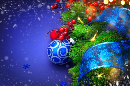 Christmas and New Year holiday background. Decorated Christmas tree over blueの写真素材