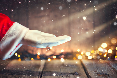Christmas Santa Claus showing empty copy space on the open hand palm for text. Advertisement gesture presenting pointの写真素材
