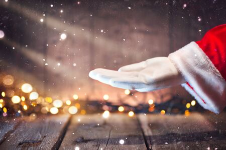 Christmas Santa Claus showing empty copy space on the open hand palm for text. Advertisement gesture presenting pointの写真素材