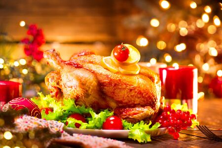 Christmas holiday family dinner. Decorated table with roasted turkey, Christmas treeの写真素材