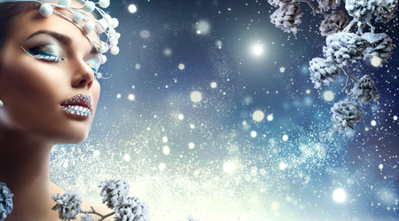 Christmas beauty girl. Winter holiday makeup with gems on lipsの写真素材