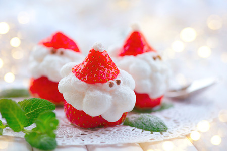 Christmas strawberry Santa. Funny dessert stuffed with whipped cream. Xmas party food ideaの写真素材
