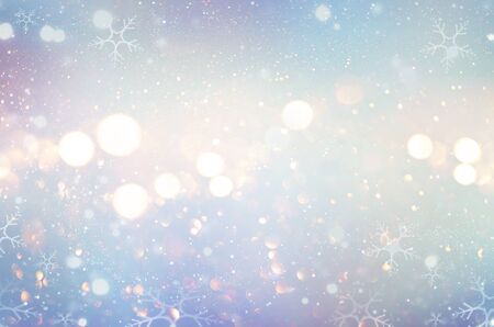 Christmas glow winter background. Defocused snow background with blinking stars and snowflakesの写真素材