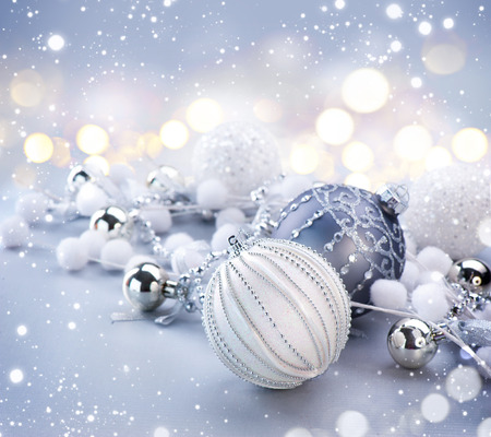 Silver Christmas and New Year Decorations on blurred grey background with lightsの写真素材