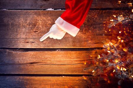 Christmas. Santa showing empty copy space on a wooden backgroundの写真素材