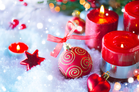 Red Christmas and New Year decorations over white snow backgroundの写真素材