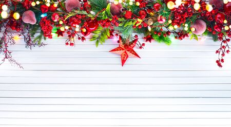 Christmas and New Year decoration over white wooden background. Border art design with holiday baublesの写真素材