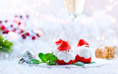 Christmas strawberry Santa. Funny dessert stuffed with whipped cream. Xmas party food ideaの写真素材