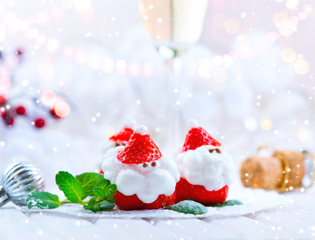Christmas strawberry Santa. Funny dessert stuffed with whipped cream. Xmas party food ideaの写真素材