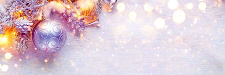 Christmas and New Year decoration over white wood background. Border art design with holiday baublesの写真素材