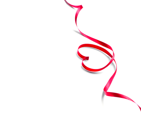 Valentine's day background. Red heart shaped satin gift ribbon isolated on whiteの写真素材