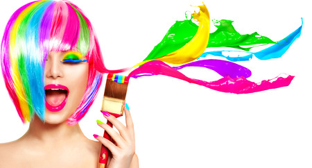 Dyed hair humor concept. Beauty model woman painting her hair in colourful bright colorsの写真素材